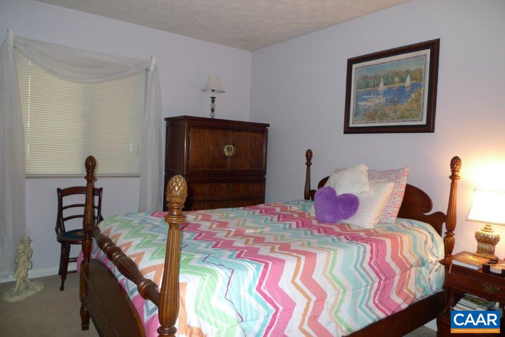 110 Turtle Creek Road, Unit 1 Charlottesville, VA 22901 - Photo 5 of 8 a bedroom with a bed and wooden floor