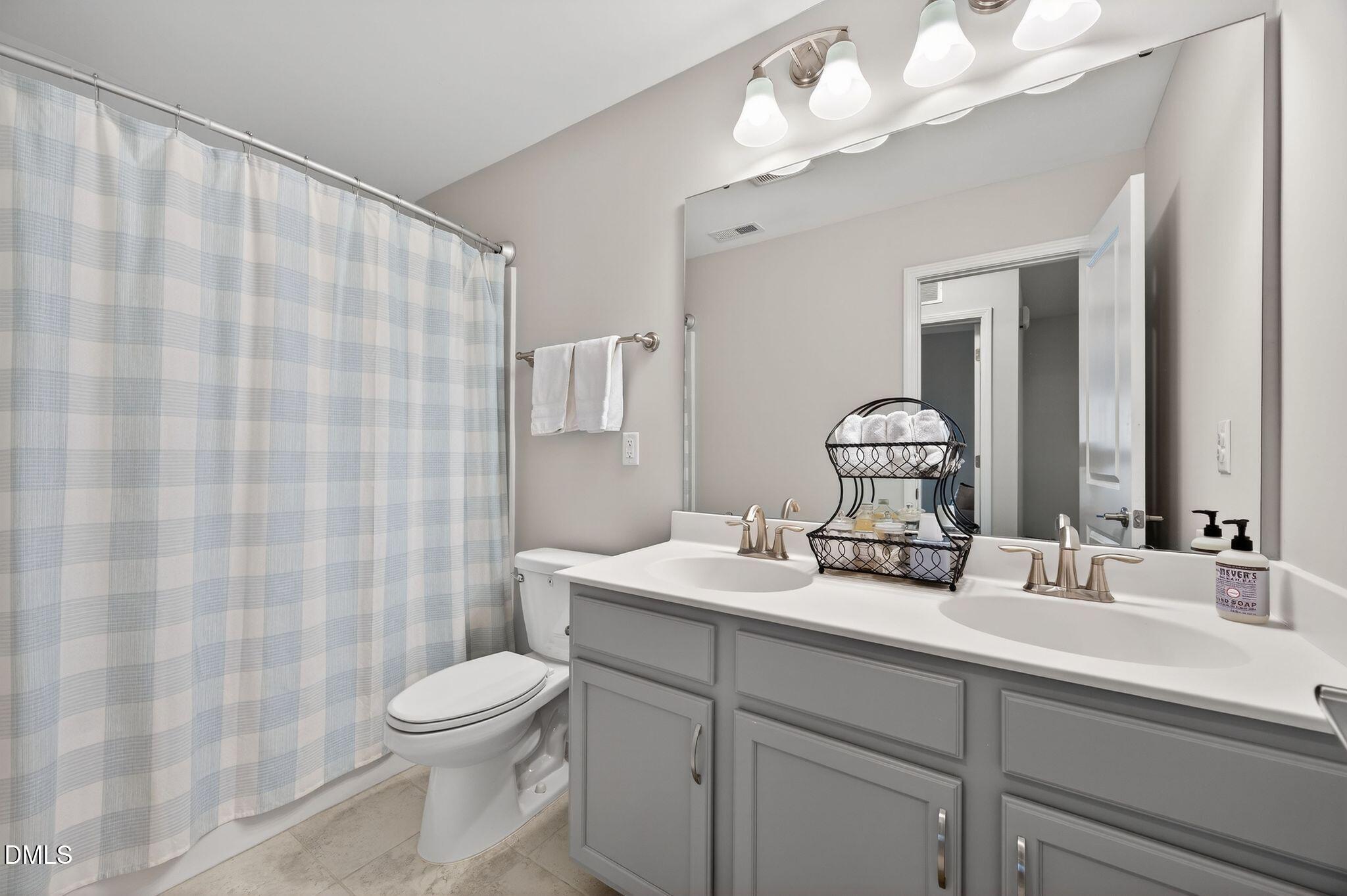 528 Spring Flower Court Cary, NC 27511 - Photo 40 of 51 a bathroom with a sink a toilet and shower