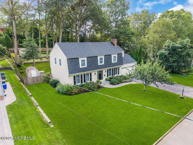 a house with green field in front of it