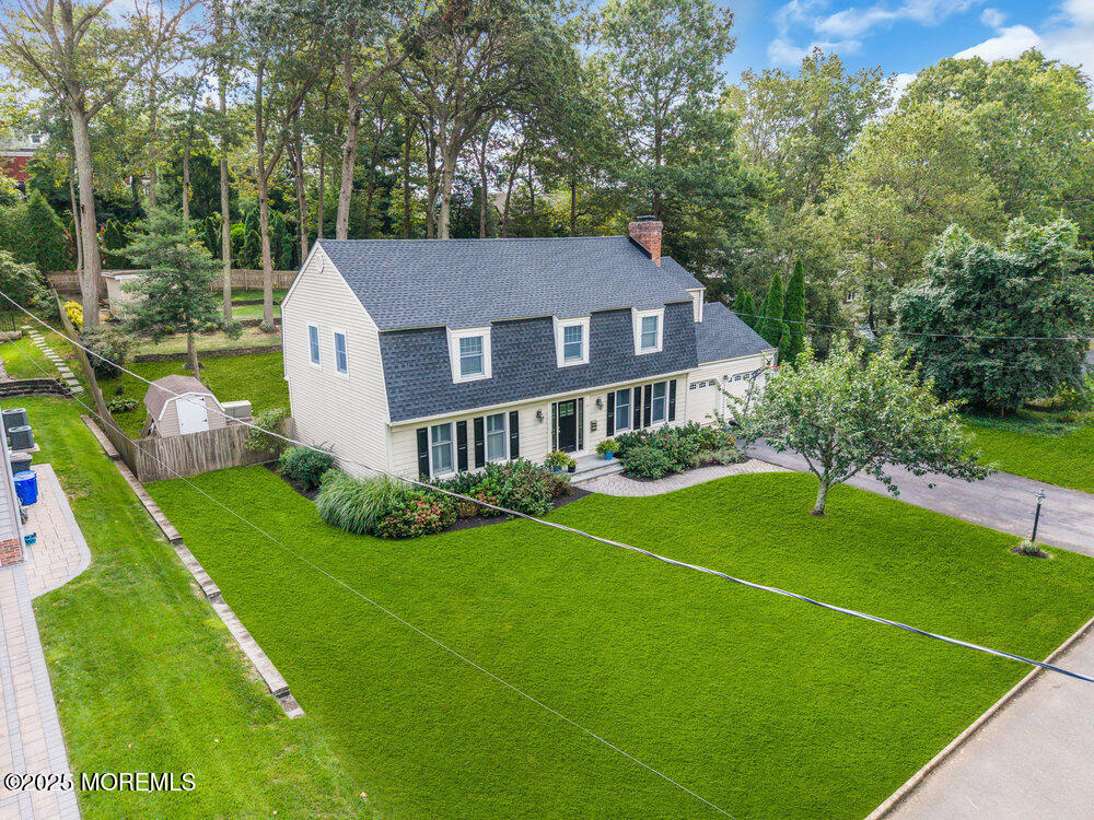 a house with green field in front of it