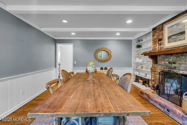 a living room with a table and a fireplace