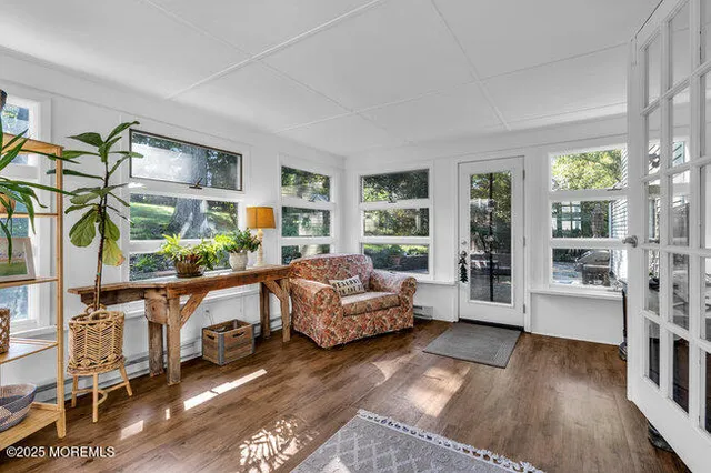 a living room with furniture and a floor to ceiling window