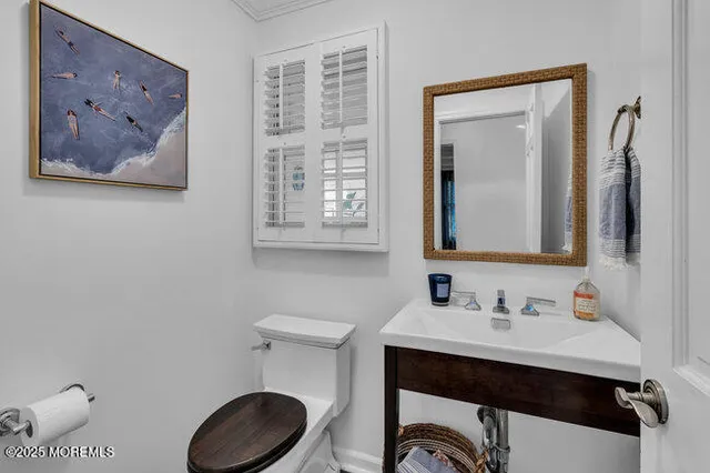 a bathroom with a toilet a sink and mirror