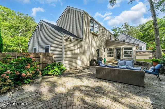 a view of house with yard and outdoor seating