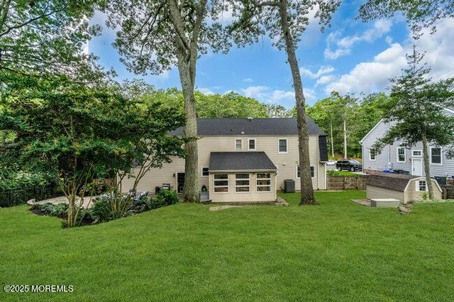 a front view of a house with a garden and trees