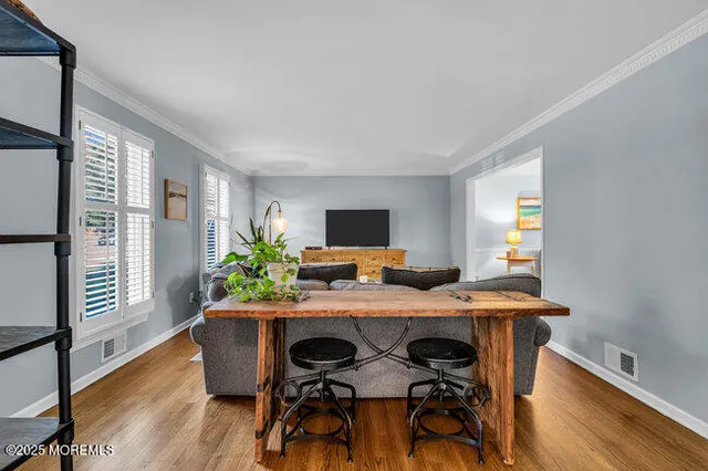 a view of a dining room with furniture window and wooden floor