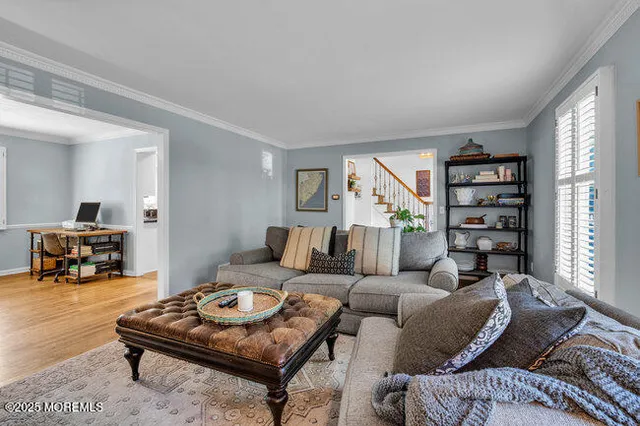 a living room with furniture a pool table and a large window