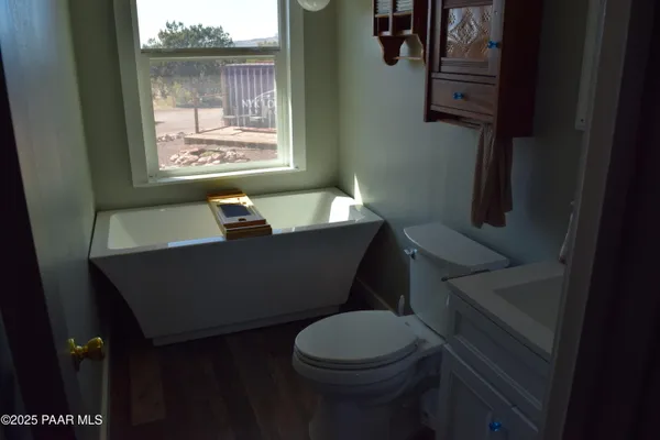 a bathroom with a toilet a sink and a window