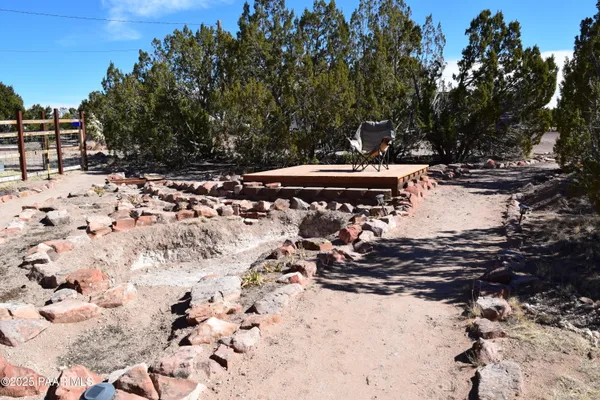 a view of a yard with snow on side of road