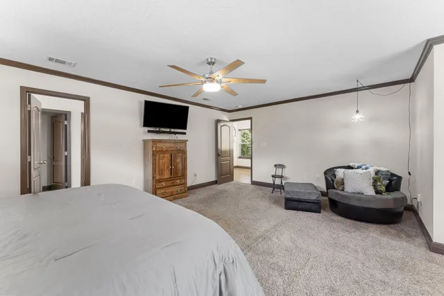 a bedroom with a double vanity sink and a mirror