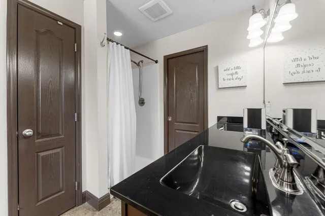 an empty room with fan and windows