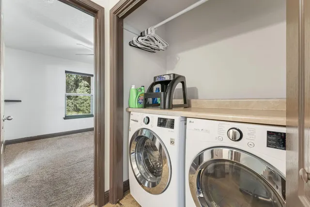 an empty room with fan and windows