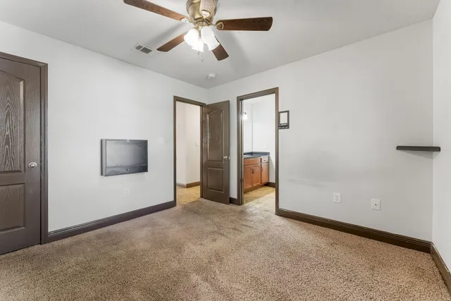 a spacious bathroom with a double vanity sink and a mirror