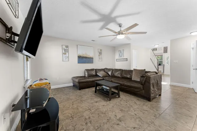 a living room with furniture and kitchen view