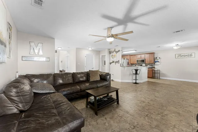a kitchen with granite countertop a refrigerator stove and microwave