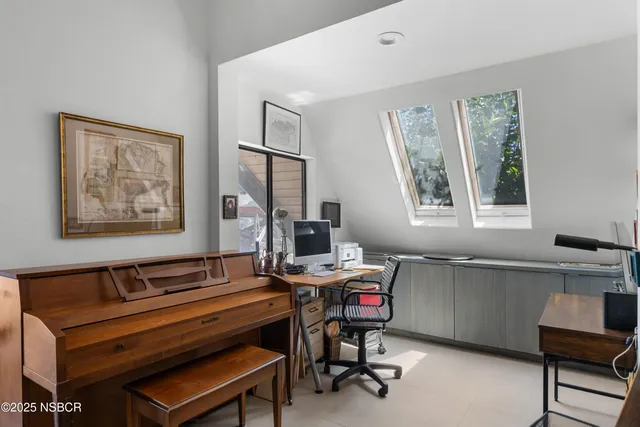 a open kitchen with stainless steel appliances granite countertop a stove top oven a refrigerator a dining table and chairs with wooden floor