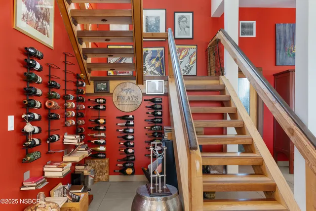 a balcony with wooden floor and outdoor seating