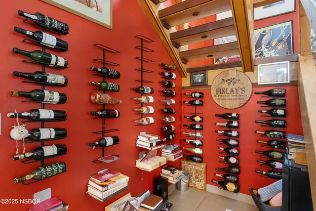 a front view of a house with plants and trees