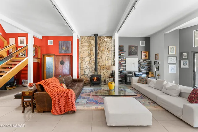 a living room with furniture a couch and a large window