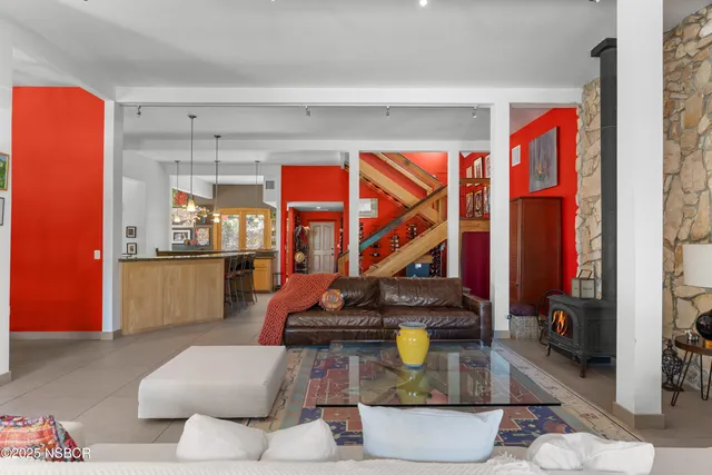 a kitchen with a table chairs refrigerator and cabinets