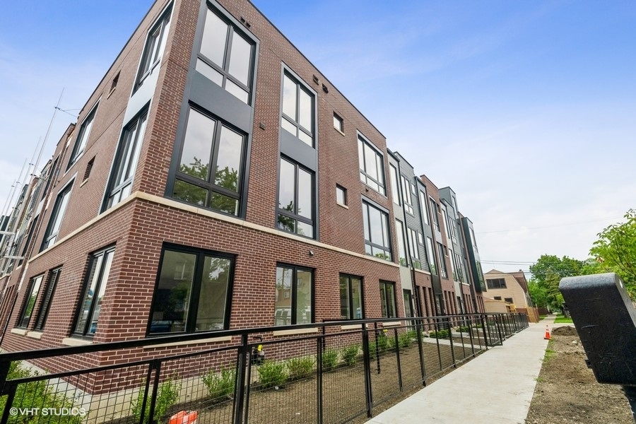 4232 West Belmont Avenue, Unit 6 Chicago, IL 60641 - Photo 1 of 24 a view of a building from a balcony