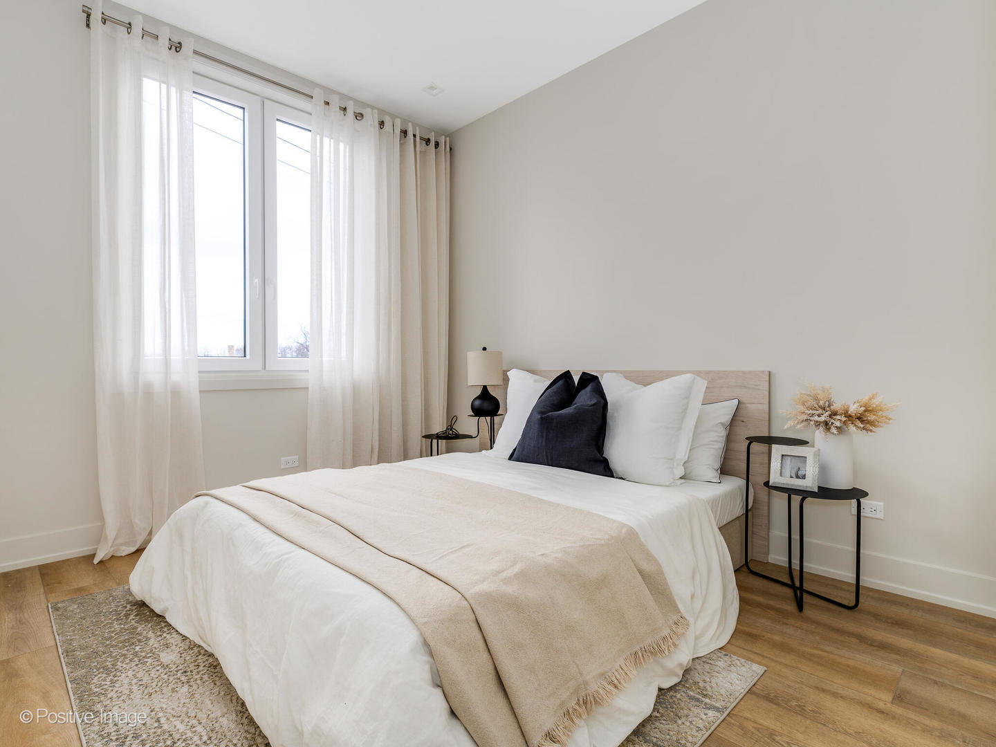 4232 West Belmont Avenue, Unit 6 Chicago, IL 60641 - Photo 17 of 24 a large bed sitting in a bedroom next to a window