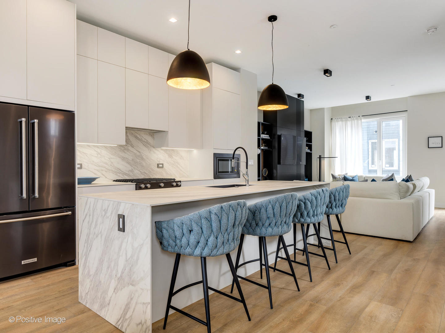 4232 West Belmont Avenue, Unit 6 Chicago, IL 60641 - Photo 2 of 24 a kitchen with stainless steel appliances granite countertop a dining table chairs and a refrigerator