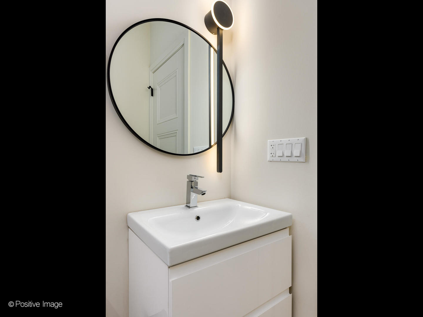 4232 West Belmont Avenue, Unit 6 Chicago, IL 60641 - Photo 23 of 24 a bathroom with a sink and a mirror