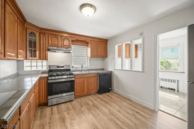 a kitchen with granite countertop a stove and a sink