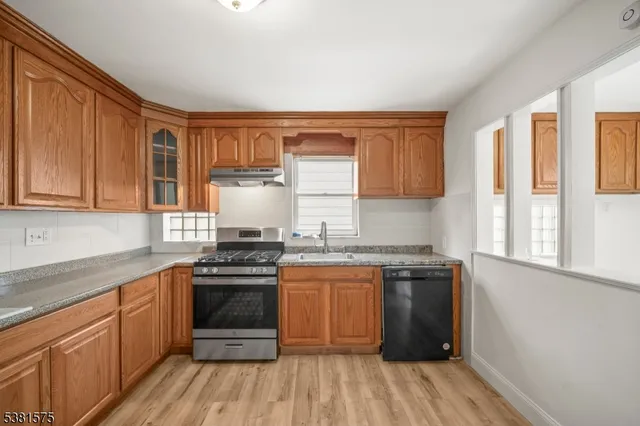 a kitchen with a sink stove and cabinets