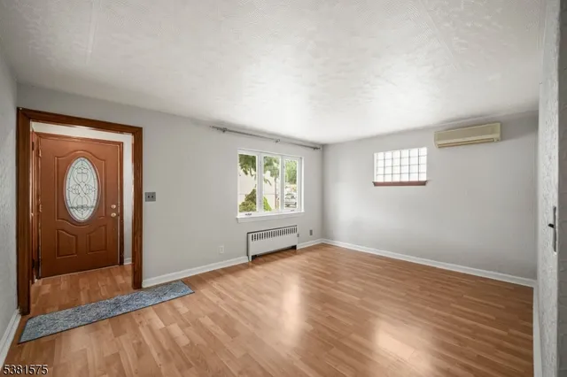 an empty room with windows and closet