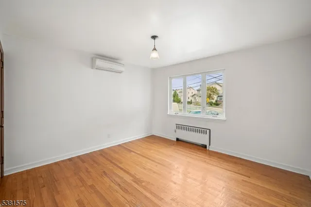 an empty room with painting on the wall