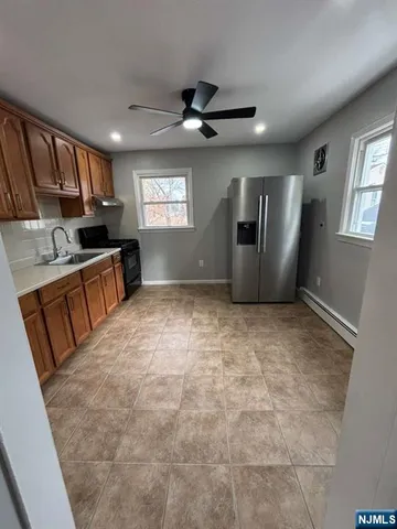 a view of a kitchen with a sink and a window