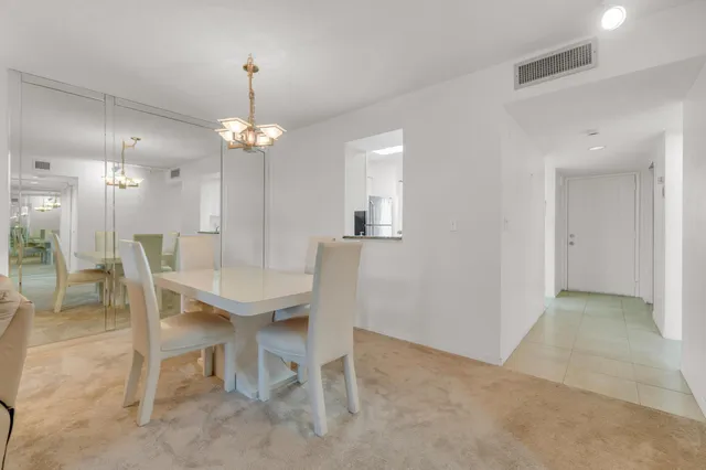 a bedroom with a large bed and a chandelier fan