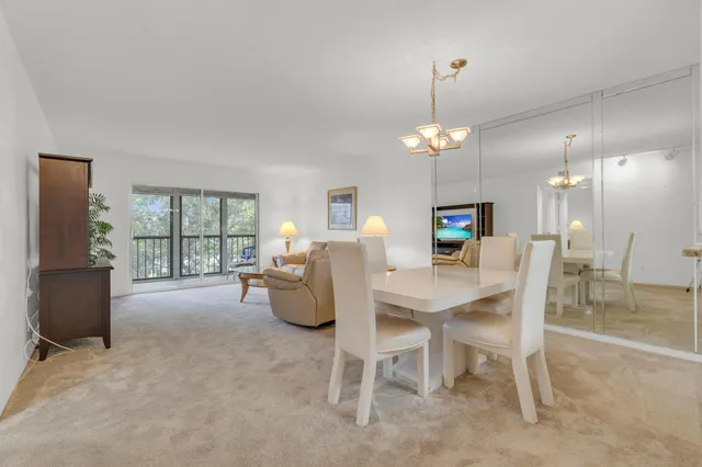 a bathroom with a granite countertop sink mirror and toilet