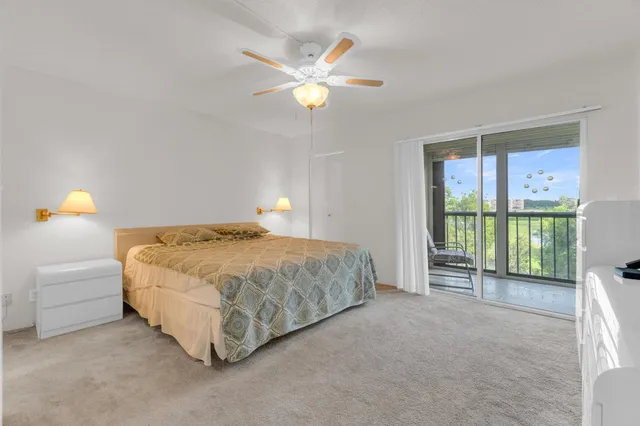 a bathroom with a granite countertop sink a mirror and a toilet