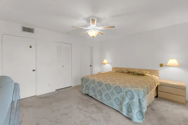 a en suite bathroom with a granite countertop sink and a mirror