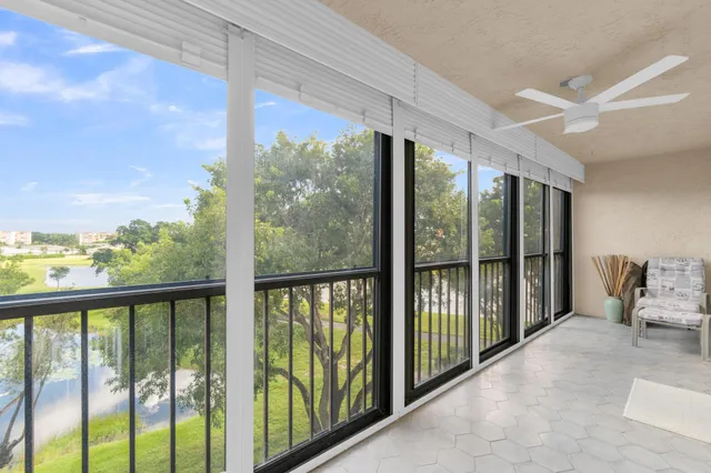 a sign on the side of the grass and the wall