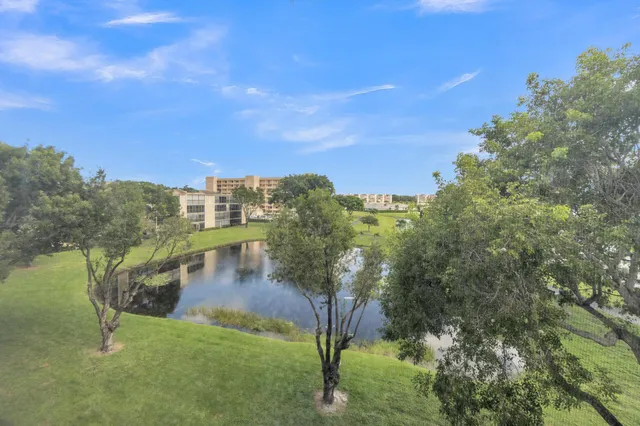 a living room with a couch and a view of kitchen