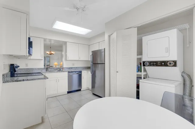 a bathroom with a refrigerator and a table