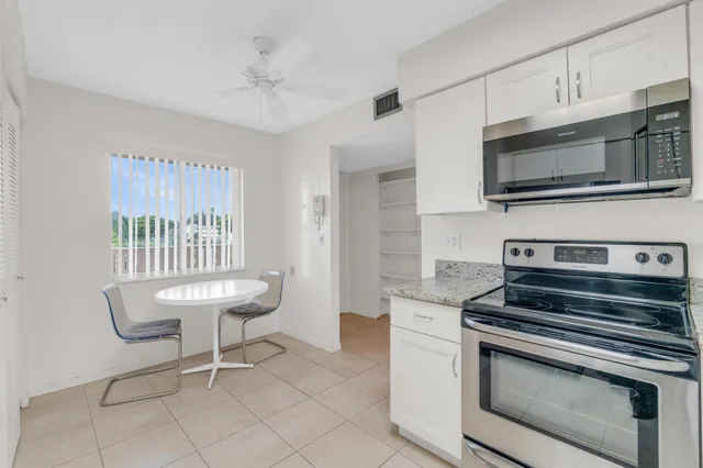 a living room with furniture a chandelier and a flat screen tv