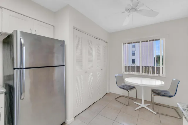a living room with furniture a lamp and a painting