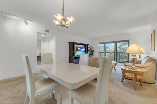 a very nice looking dining room with a table and chairs