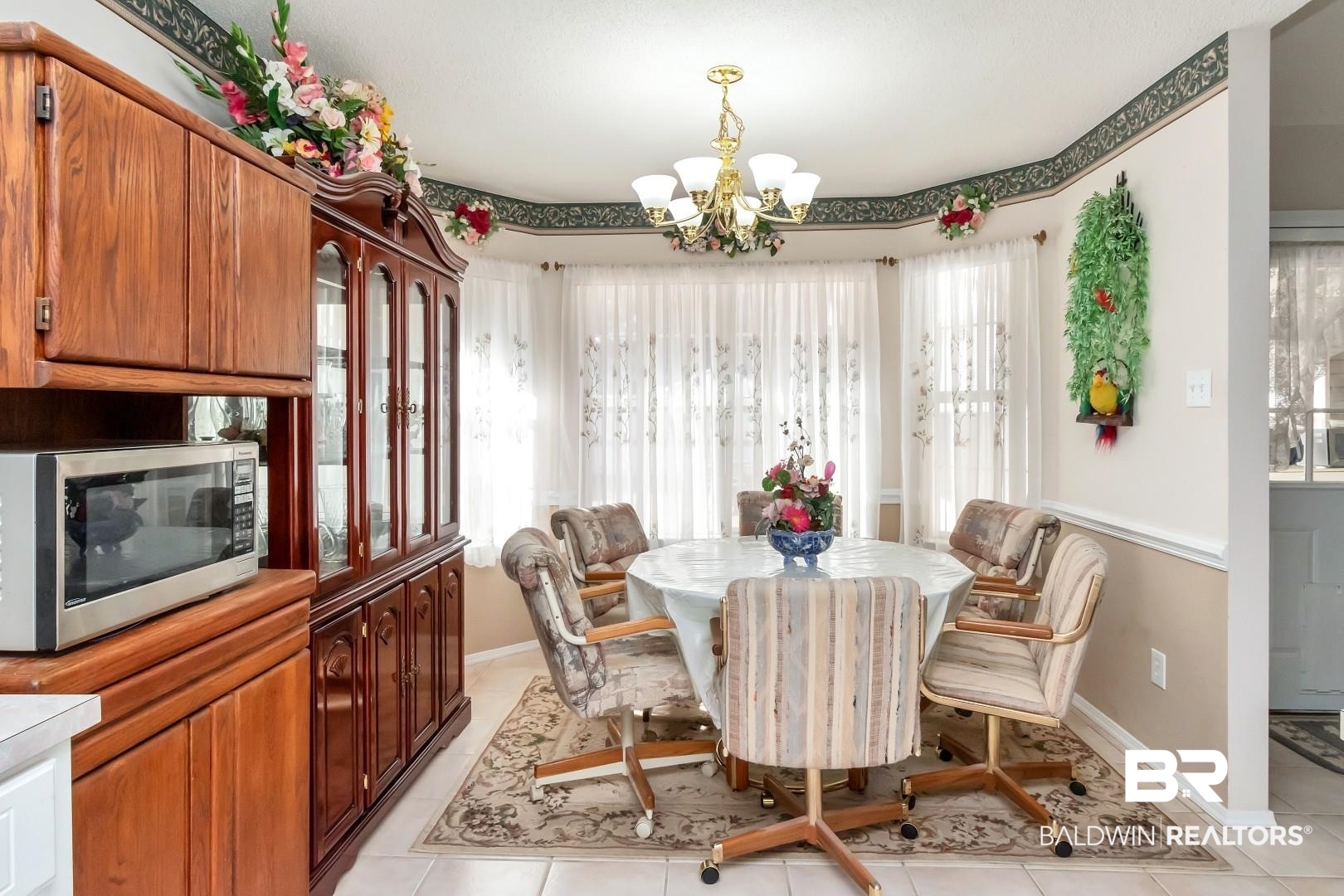8221 Woodbend Drive Semmes, AL 36575 - Photo 17 of 35 Dining room featuring a chandelier and light tile patterned flooring