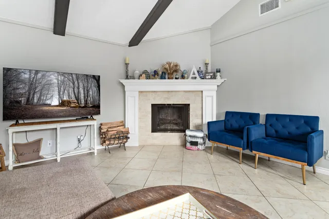 a living room with furniture and a fireplace