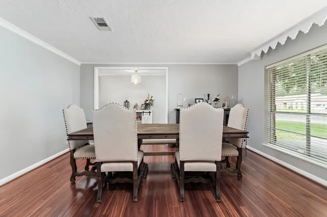a view of a dining room with furniture and wooden floor