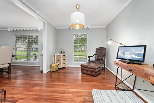 a living room with furniture and a chandelier