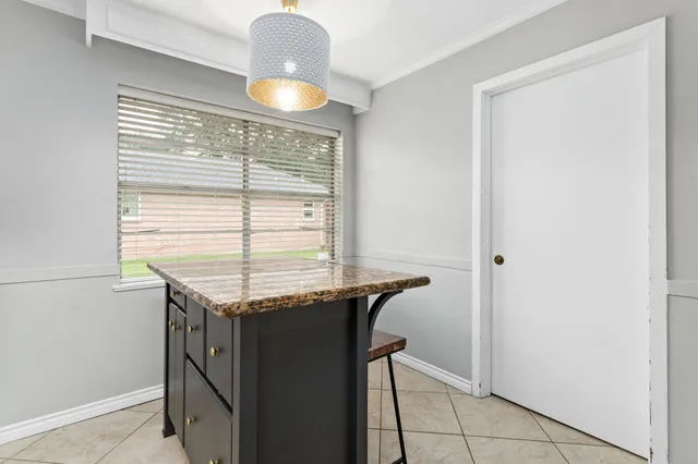 a kitchen with granite countertop a sink and a stove