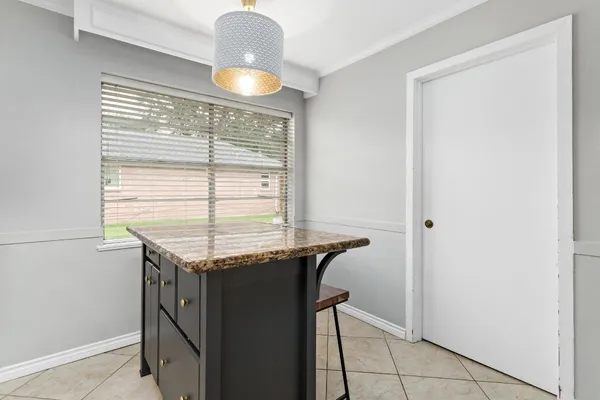 a kitchen with granite countertop a sink and a stove
