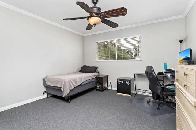 a bedroom with a bed and a desk